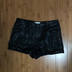 Black leather shorts with zipper accents